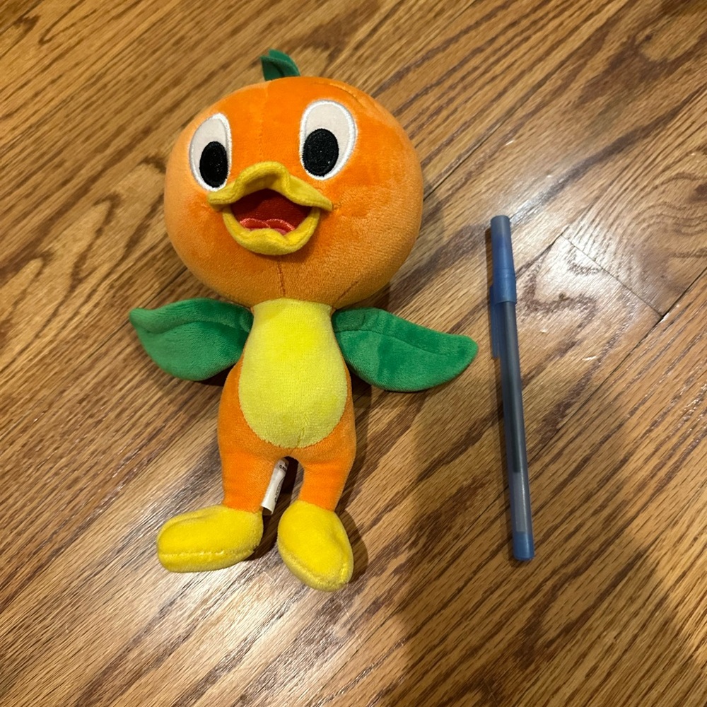 Disney Orange Bird Plush, pen for scale